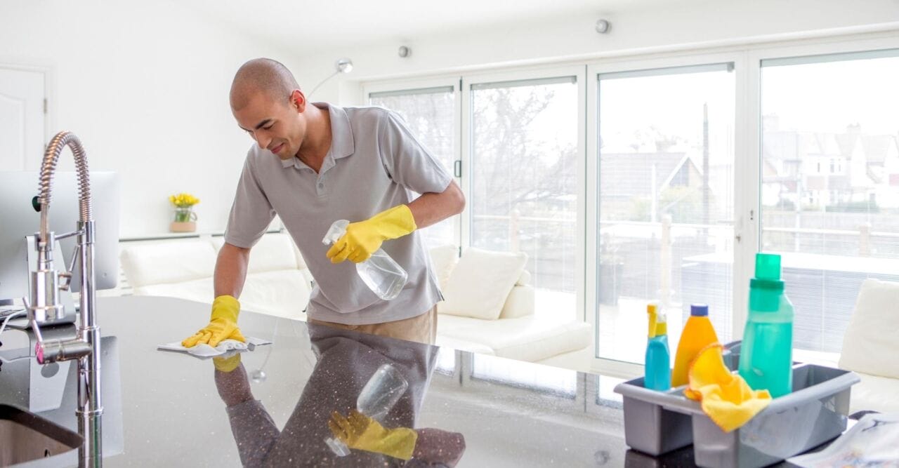 M23900 – Home Cleaners 4 You_FT Img – How We’re Dedicated to Giving You the Best House Cleaning Experience Man cleaning kitchen countertops
