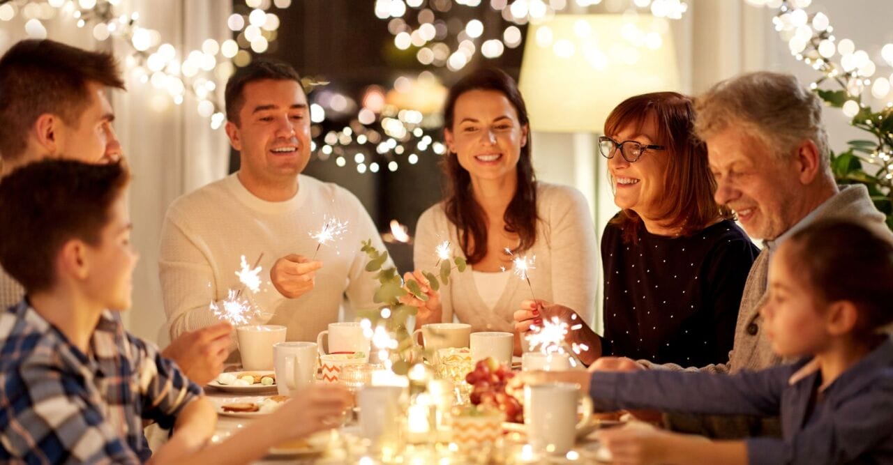 hero image 1 Family holding sparklers around table