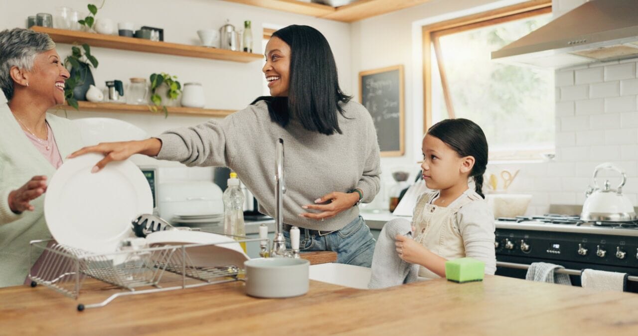 Child cleaning the kitchen with her grandmother and mother while in Northern Virginia