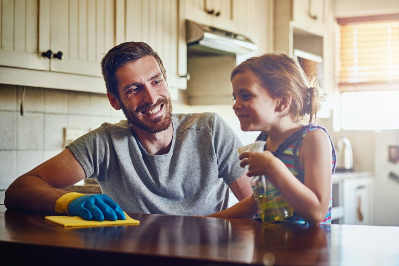 Father child and spray for cleaning in kitchen wipe dirt in Northern Virginia